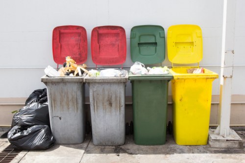 Front of a skip and waste collection vehicle at a depot